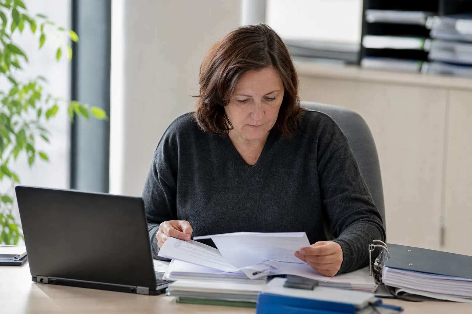 Datenschutzbeauftragte prüft Unterlagen zu Verarbeitungstätigkeiten an einem Schreibtisch